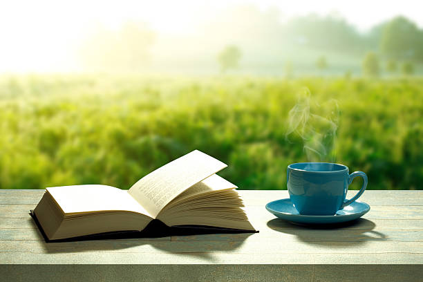 open book with a coffee cup and a wooden table 홈배경1